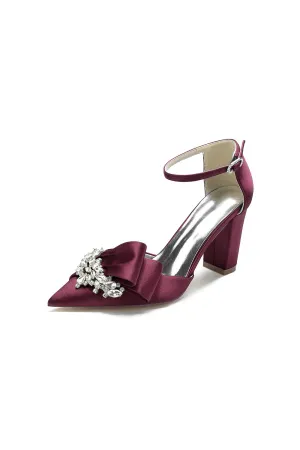 White Satin Heels Featuring a Large Decorative Bow and Metallic Heel